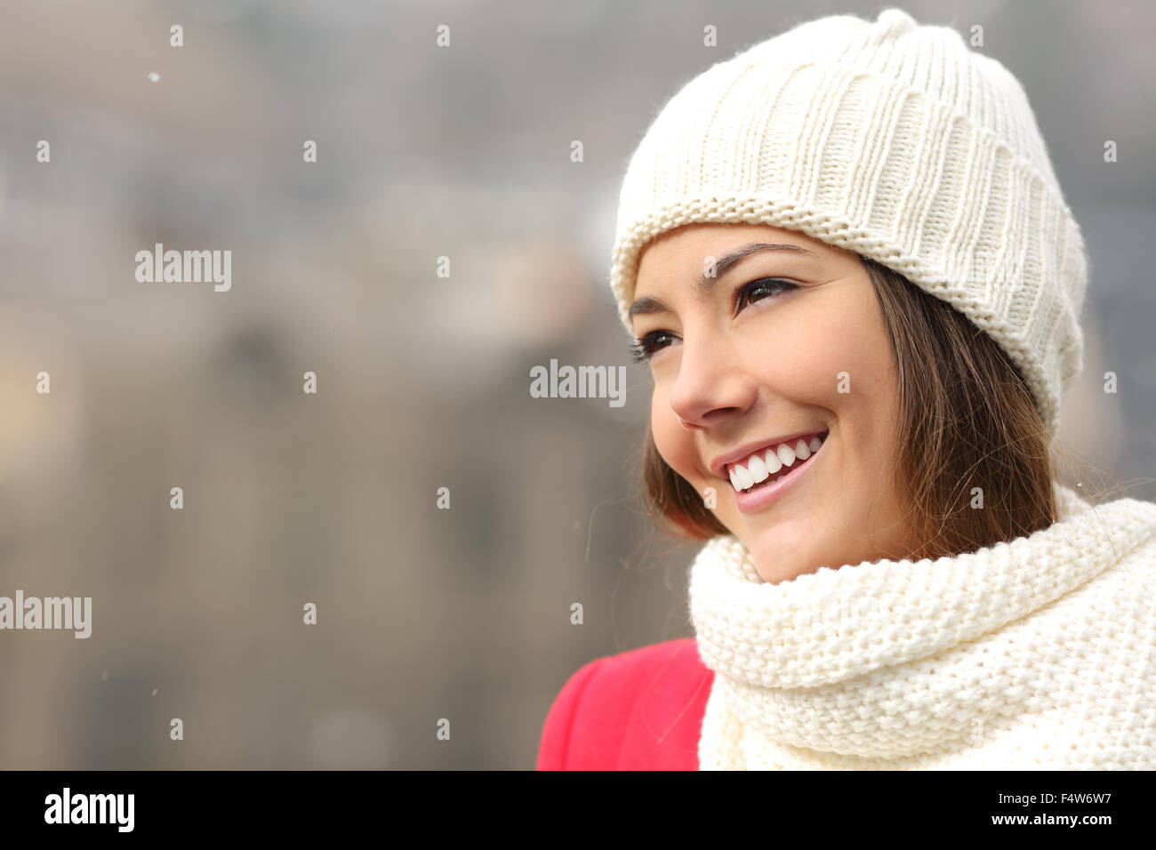 Happy candid girl with white teeth and perfect smile warmly clothed in winter Stock Photo