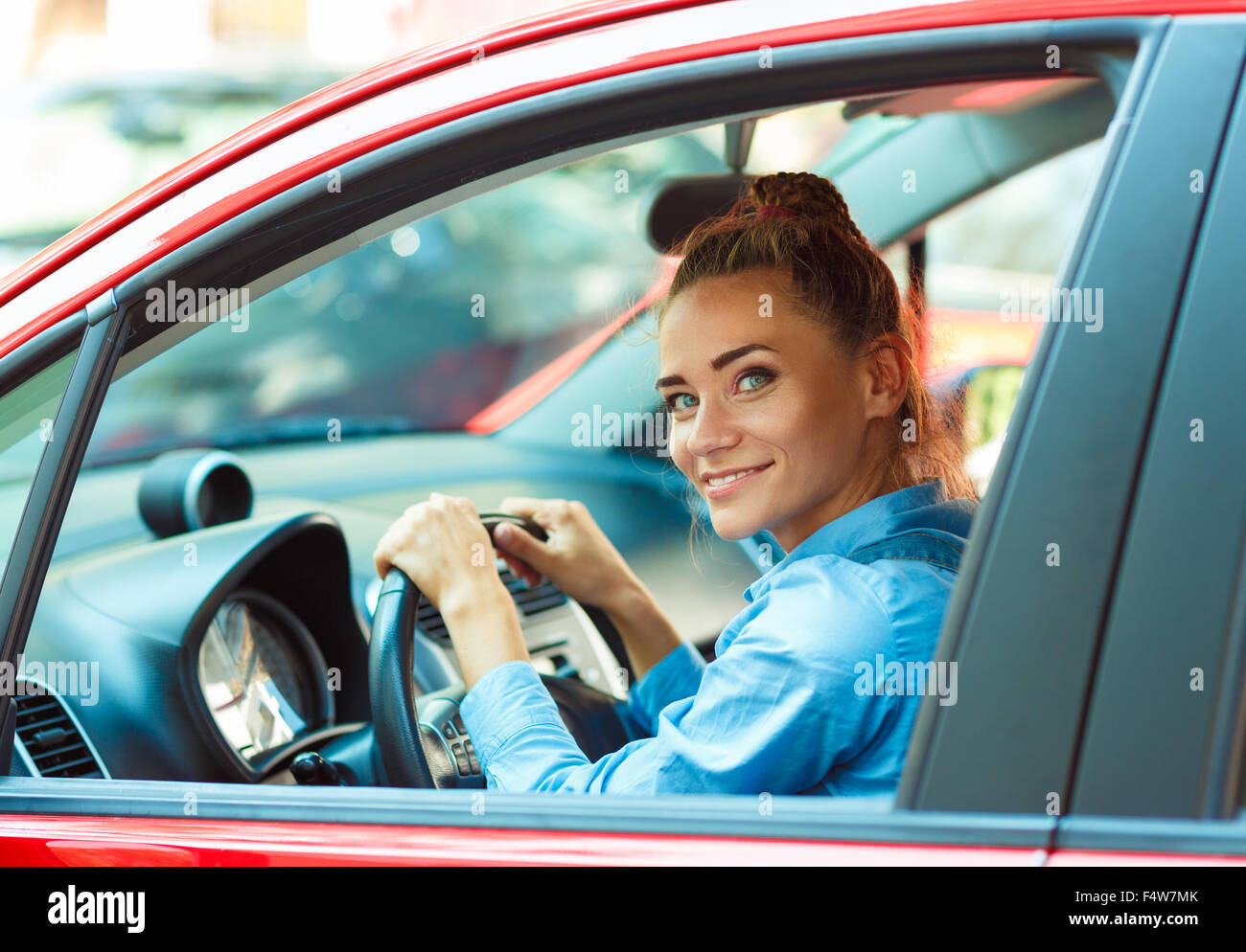 Young smiling woman driving her car Stock Photo