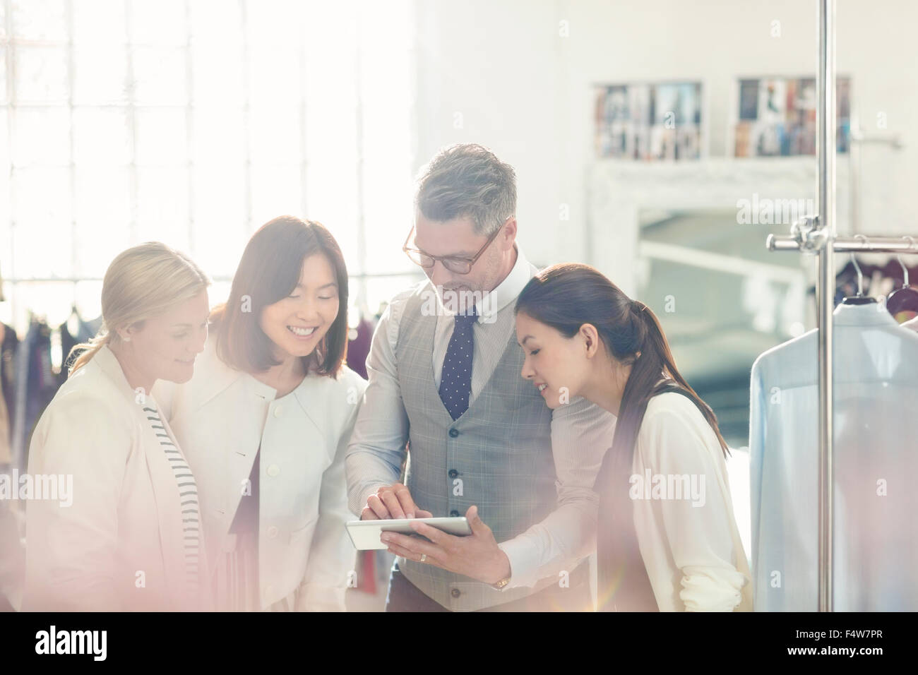 Fashion designers sharing digital tablet in office Stock Photo