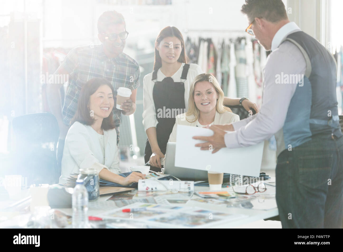 Fashion designers brainstorming with proofs and swatches in office Stock Photo
