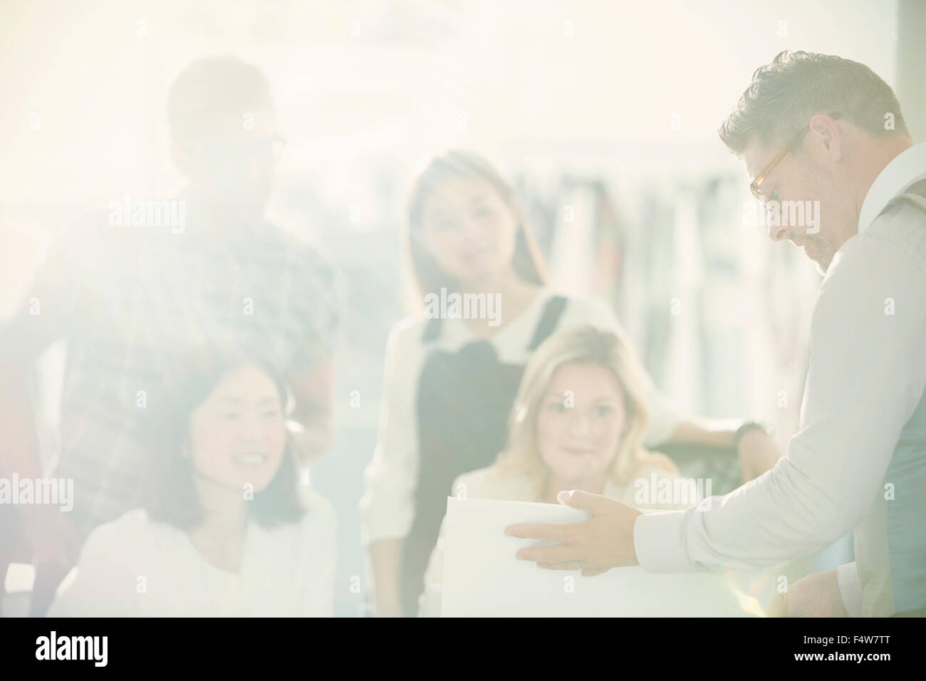 Fashion designers meeting in sunny office Stock Photo