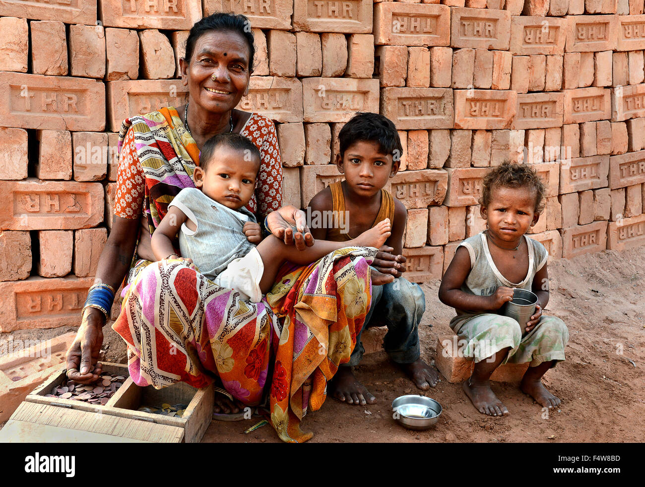 My children - The brick area worker awating with her children for some food in remote area of West Bengal. Stock Photo