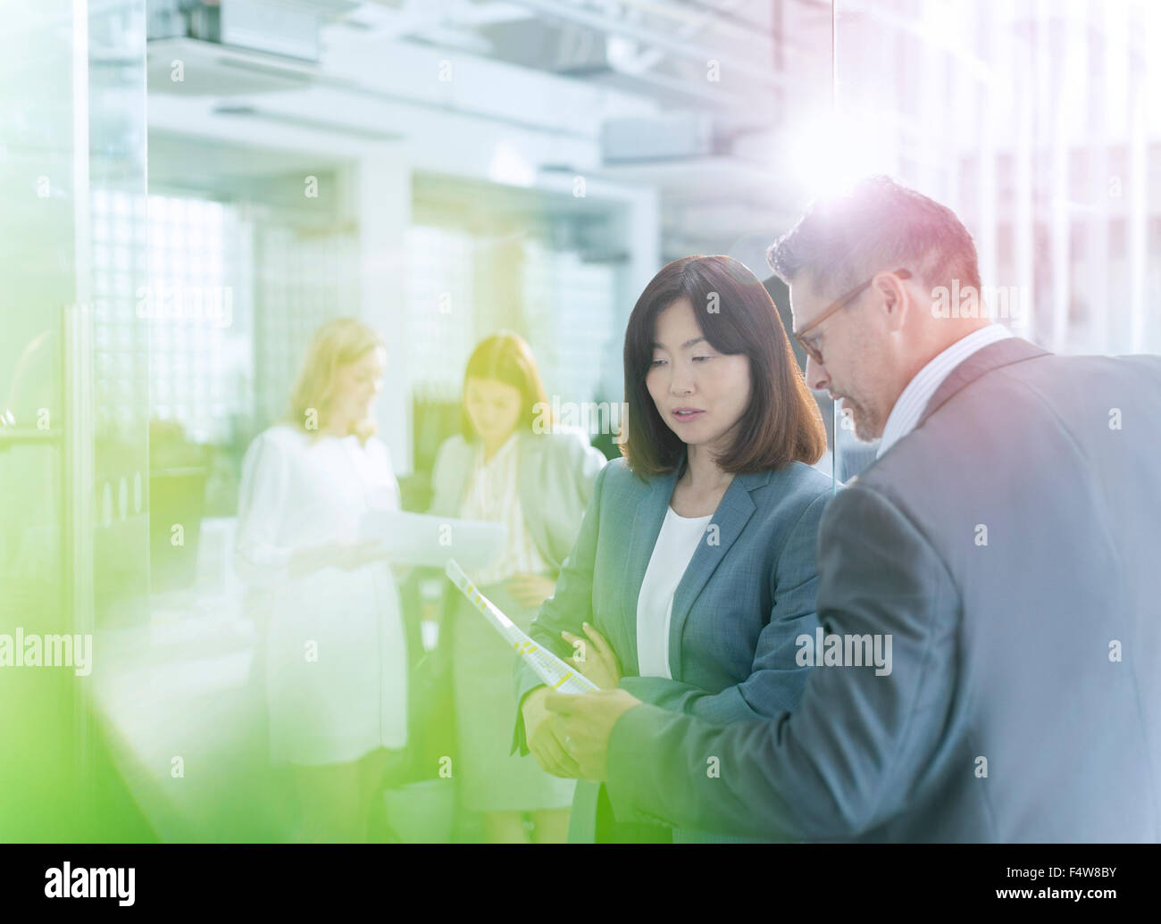 Business people discussing paperwork in office Stock Photo - Alamy
