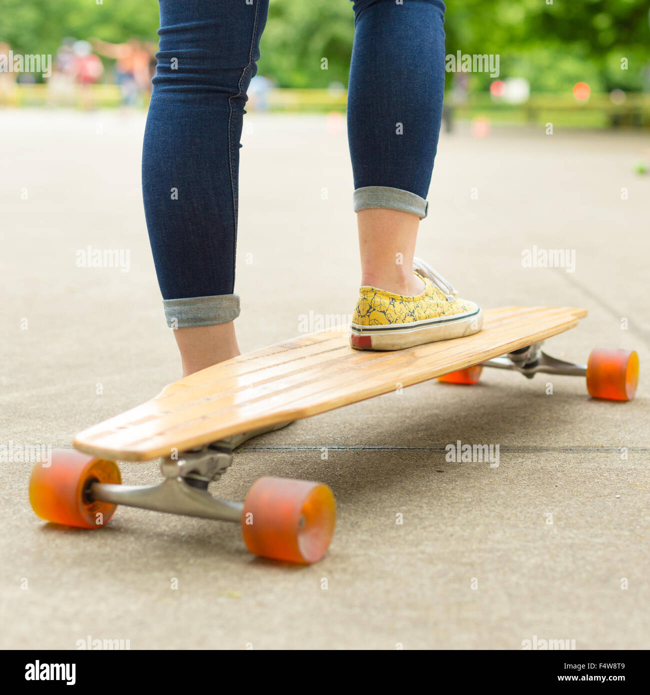 Teenage girl practicing riding long board Stock Photo - Alamy