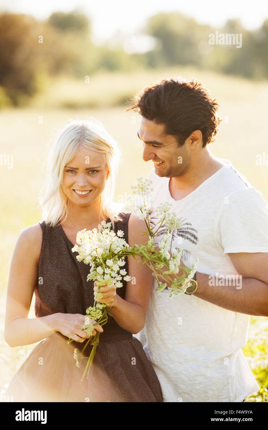 Couple with flowers hi-res stock photography and images - Alamy