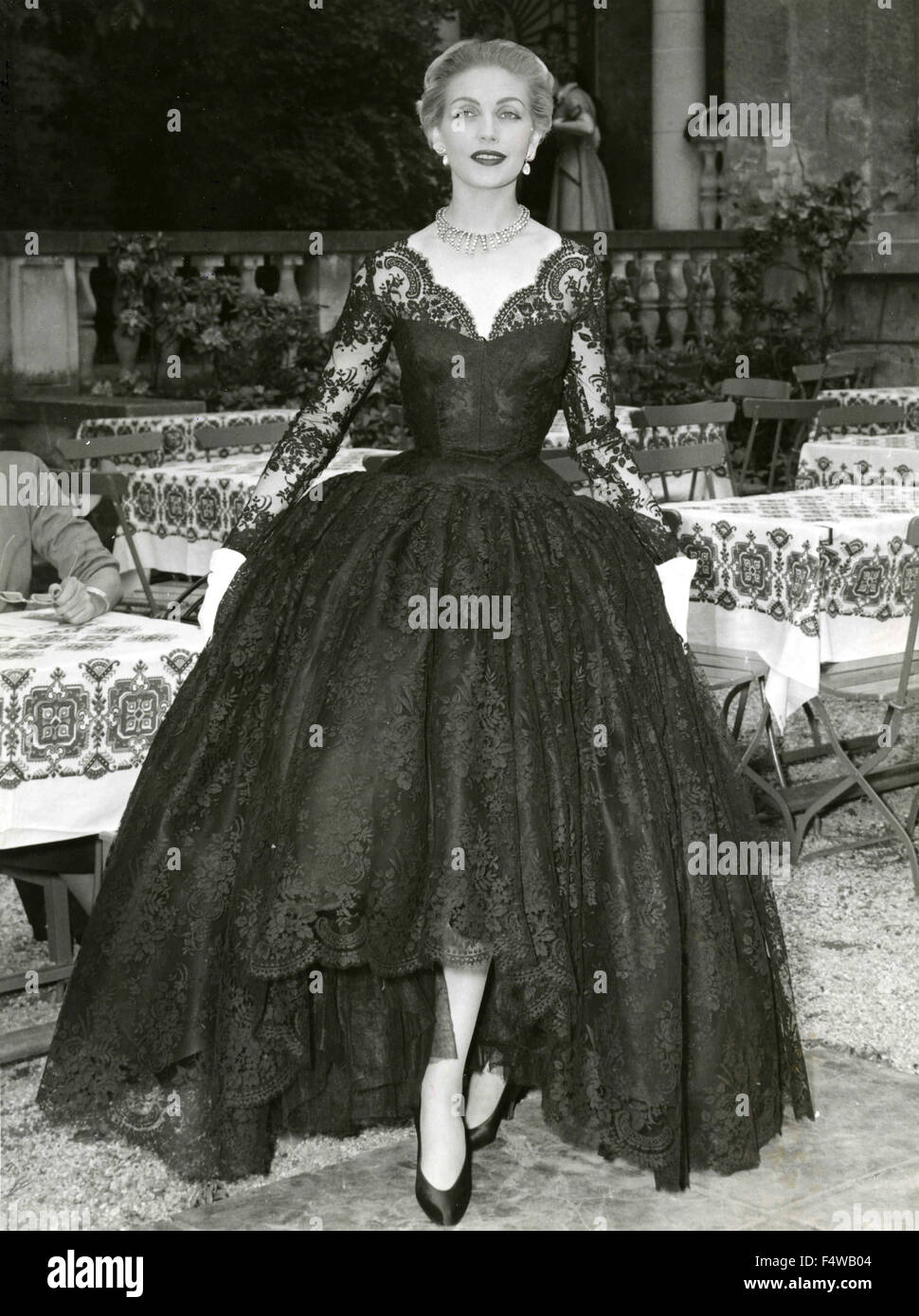 A model presents a large black lace dress Stock Photo
