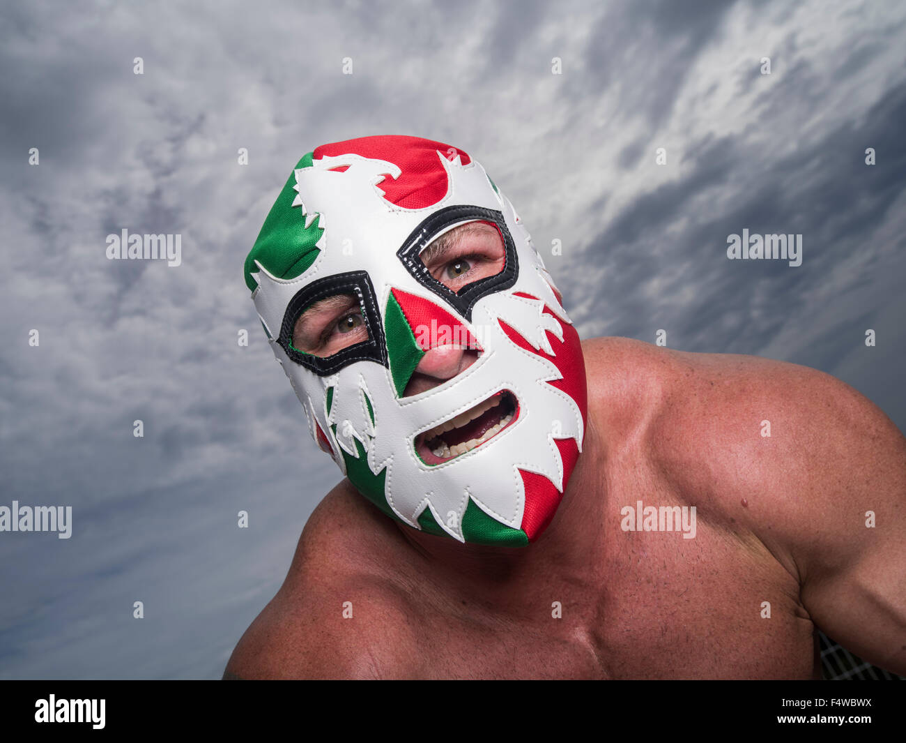 Large male muscular Wrestler with Mexican flag wrestling mask Stock Photo