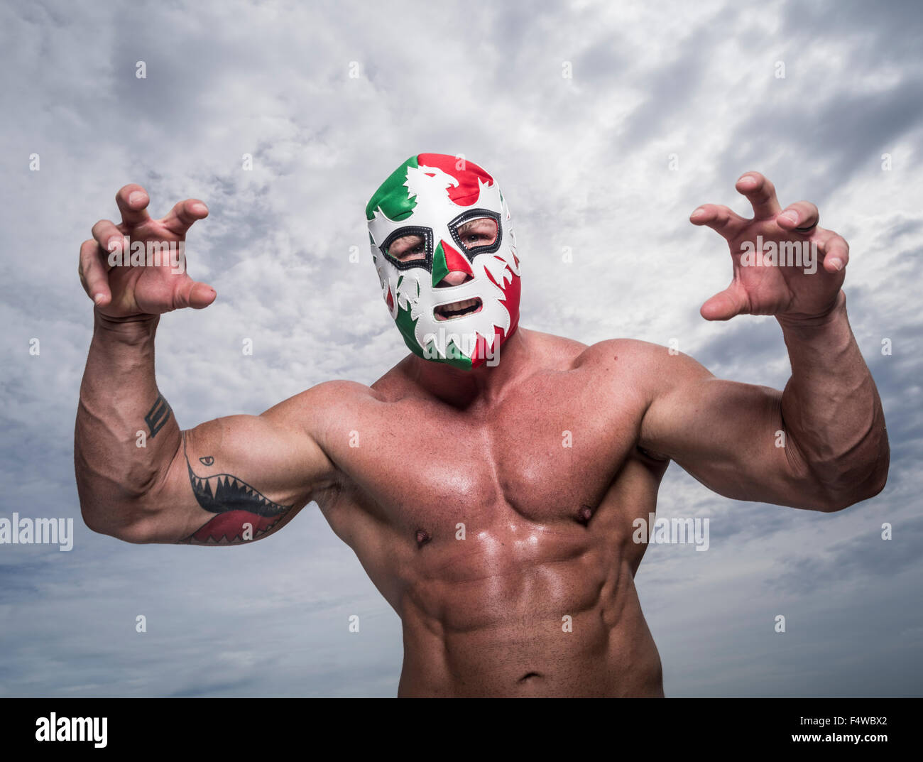 Large male muscular Wrestler with Mexican flag wrestling mask Stock Photo