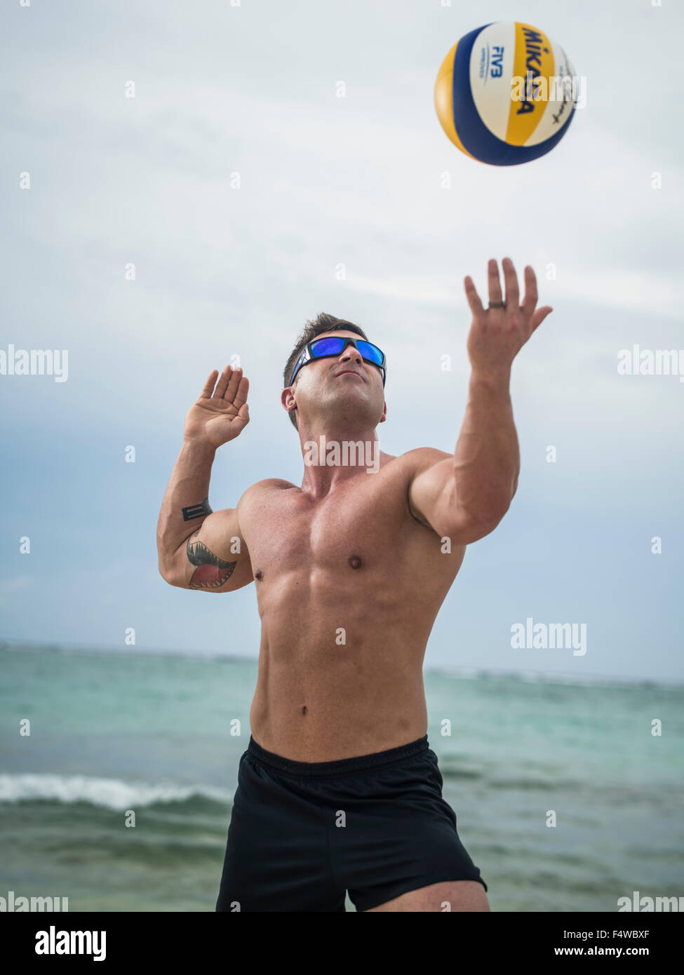 Beach volleyball player outdoors serving ball Stock Photo Alamy