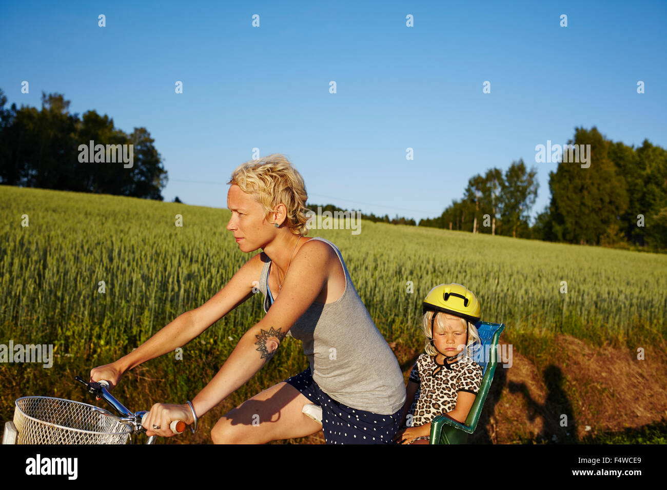 Woman with daughter (4-5) riding bike Stock Photo