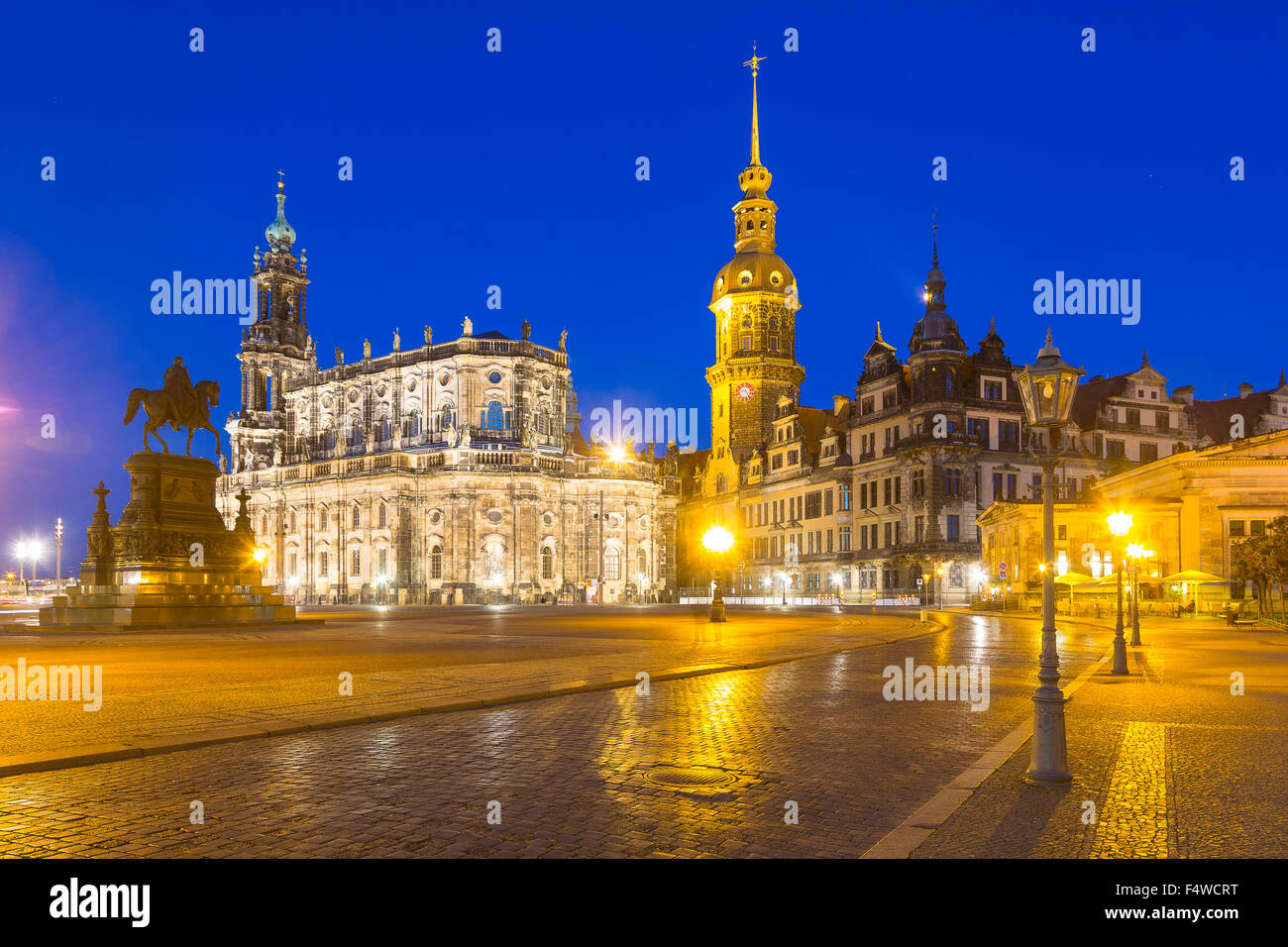 Theaterplatz, theatre square with equestrian monument, Hofkirche church, castle with Hausmannsturm tower and Schinkelwache, dusk Stock Photo