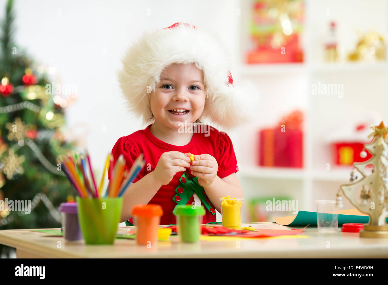Kid girl making by hands x-mas decorations Stock Photo - Alamy