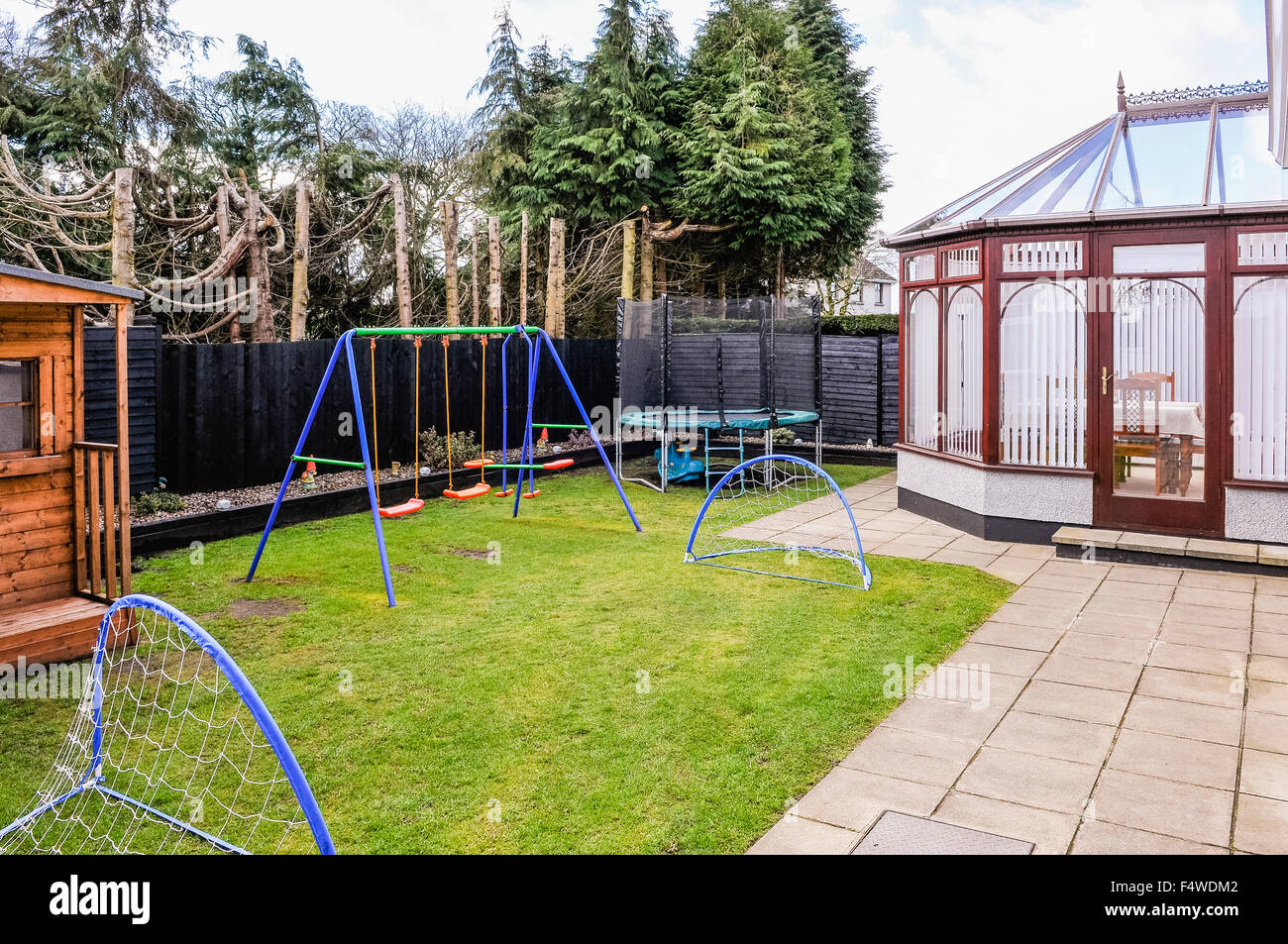 Enclosed family rear garden with childrens swings, football nets