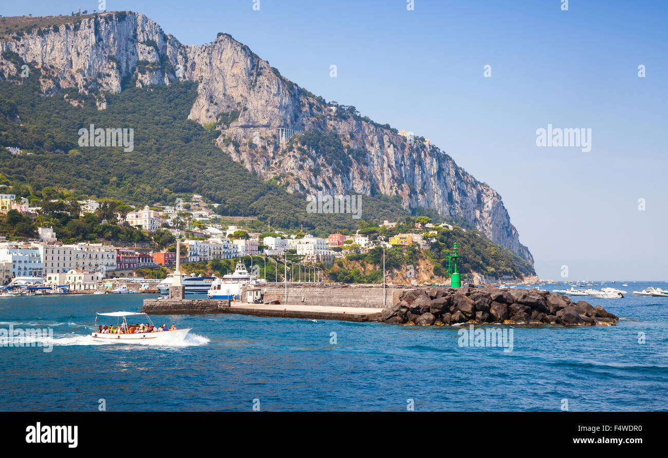 Entrance of Capri port, Italy. Breakwater with green lighthouse Stock Photo