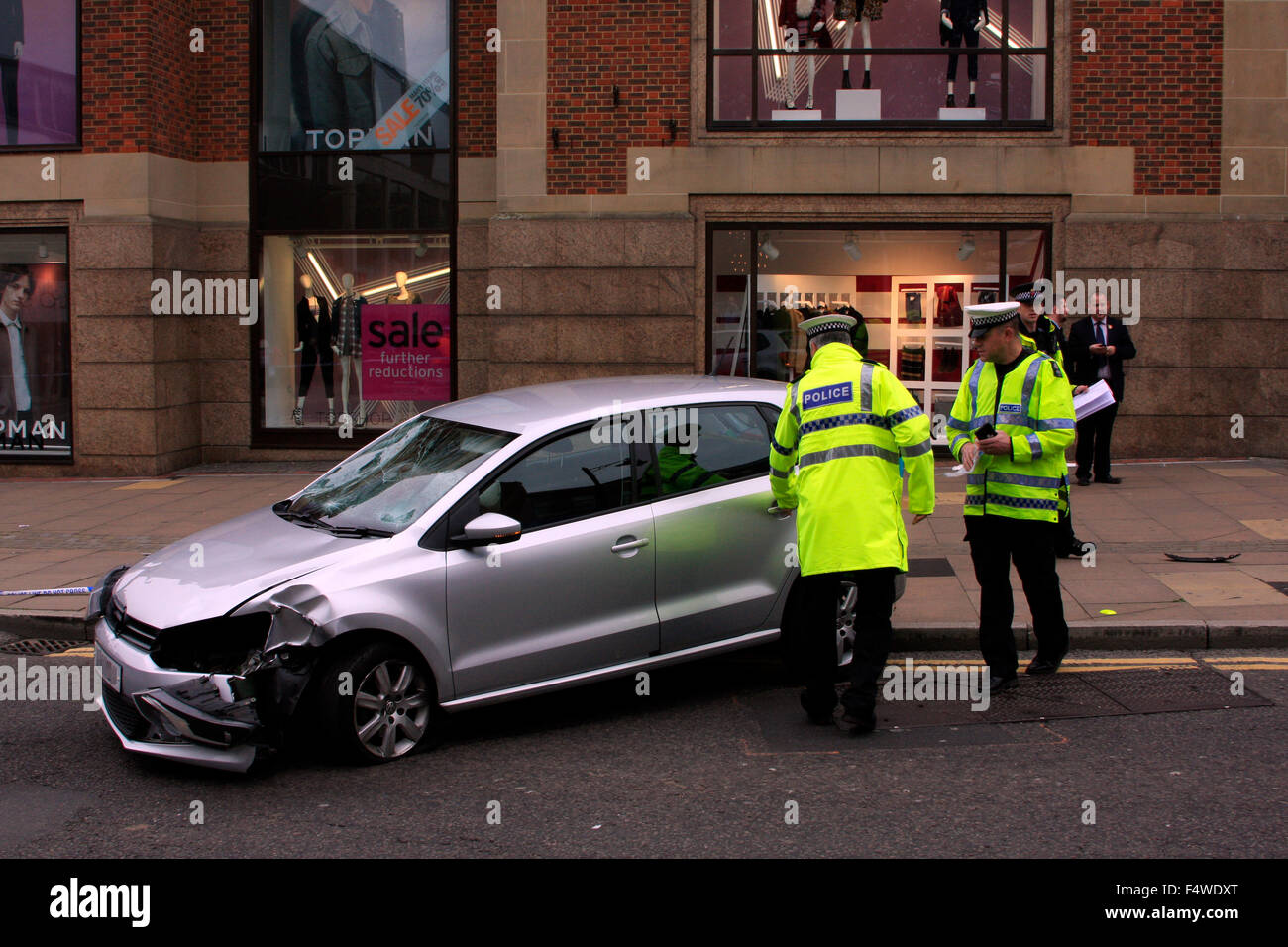 Guildford, Surrey, UK. 23rd Oct, 2015. Police watching over a car which has crashed on North Street outside The Friary Shopping Centre in Guildford. The road has been closed off pending removal of the vehicle. Credit:  Bruce McGowan/Alamy Live News Stock Photo