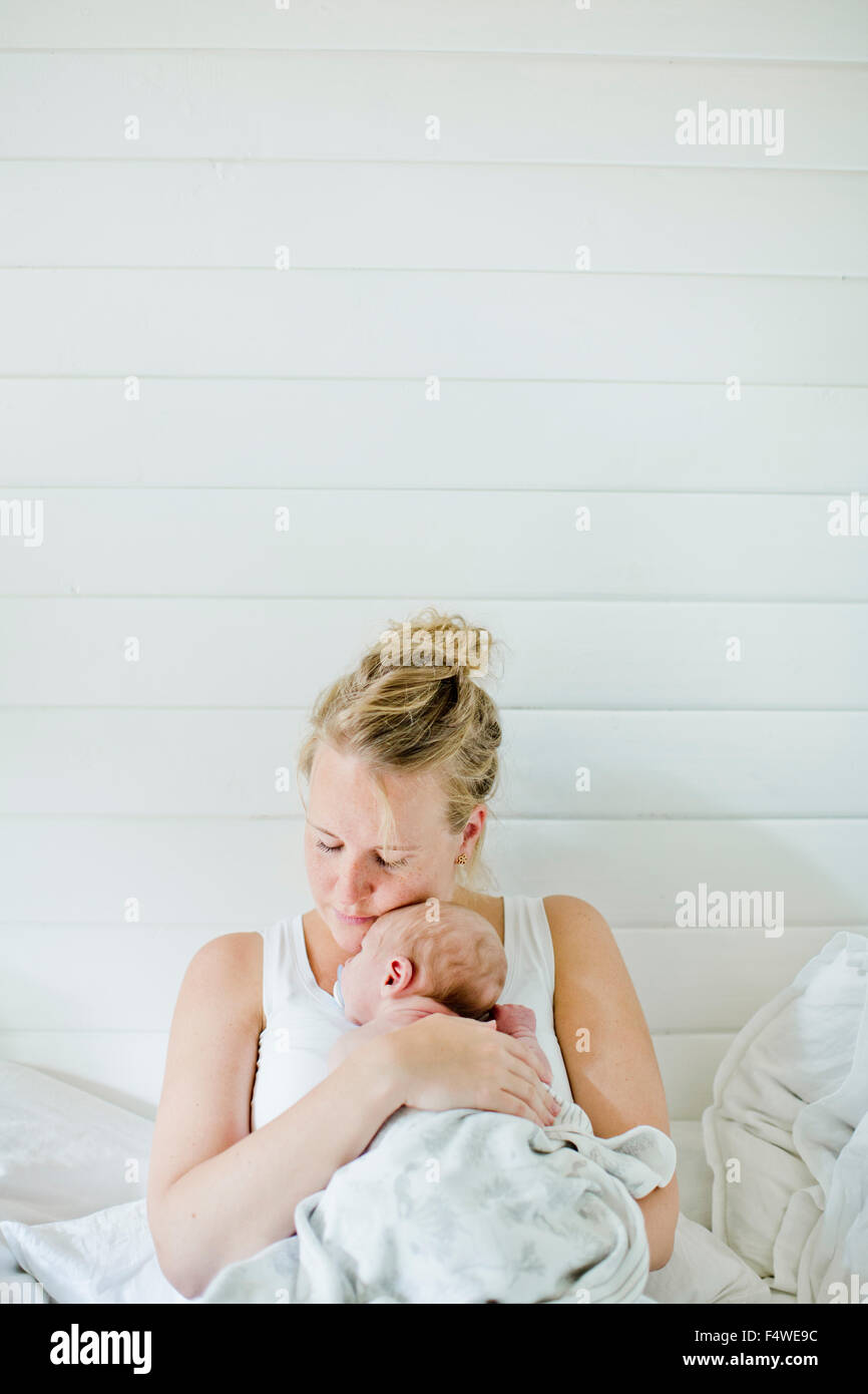 Mid-adult woman holding baby boy (0-1 months) in her arms Stock Photo