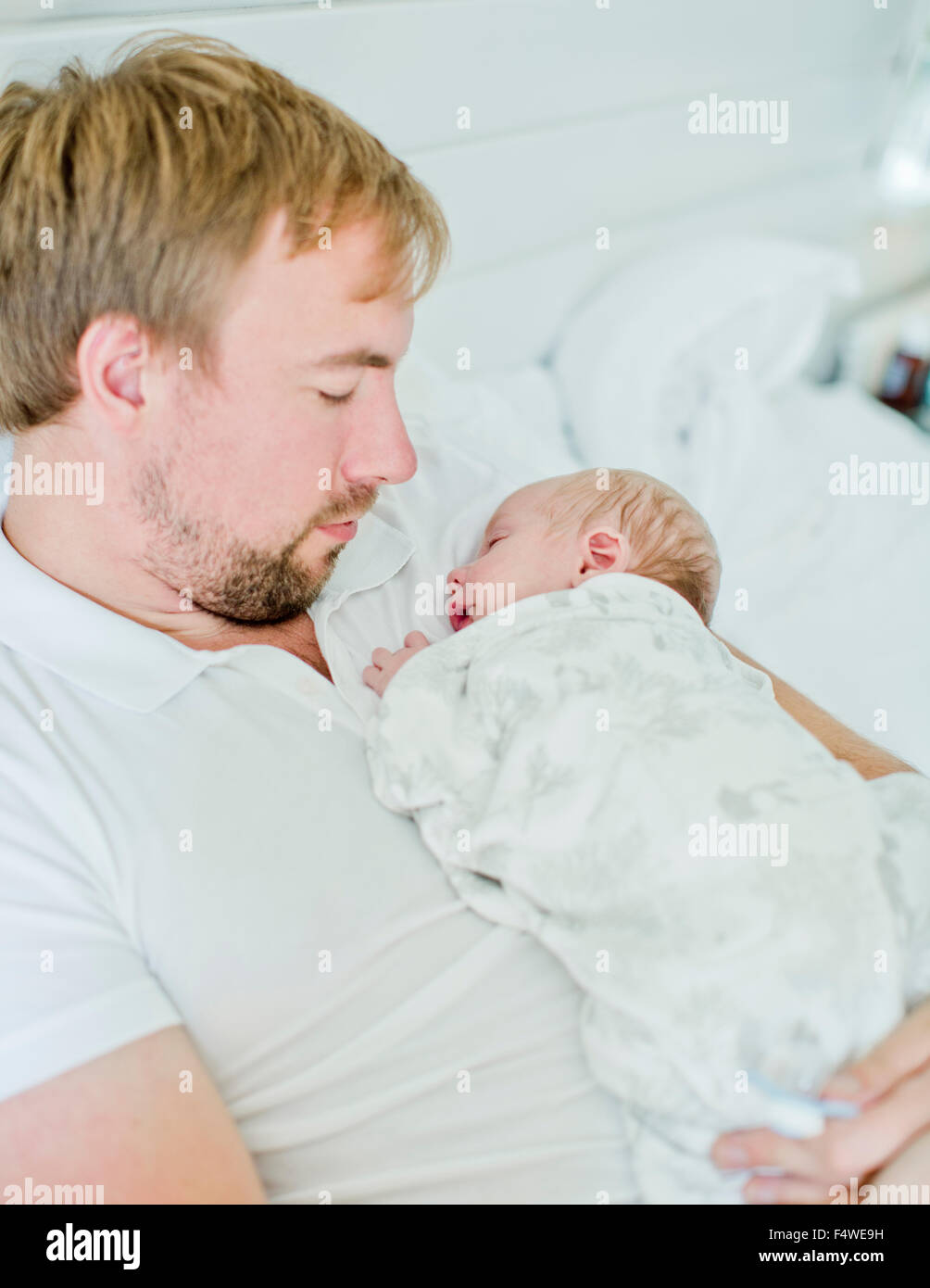 Mid-adult man holding baby boy (0-1 months) in his arms Stock Photo
