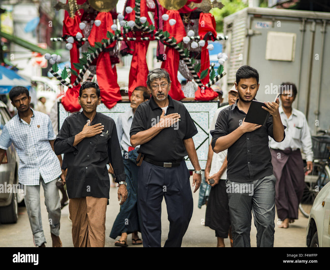 Yangon, Yangon Division, Myanmar. 23rd Oct, 2015. An Ashura procession goes past Punja Mosque in Yangon. Ashura commemorates the death of Hussein ibn Ali, the grandson of the Prophet Muhammed, in the 7th century. Hussein ibn Ali is considered by Shia Muslims to be the third imam and the rightful successor of Muhammed. He was killed at the Battle of Karbala in 610 CE on the 10th day of Muharram, the first month of the Islamic calendar. According to Myanmar government statistics, only about 4% of the population is Muslim. Many Muslims have fled Myanmar in recent years because of violence direct Stock Photo