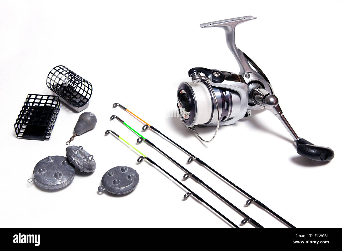 Fishing feeder and reel with accessories on white background. Fishing