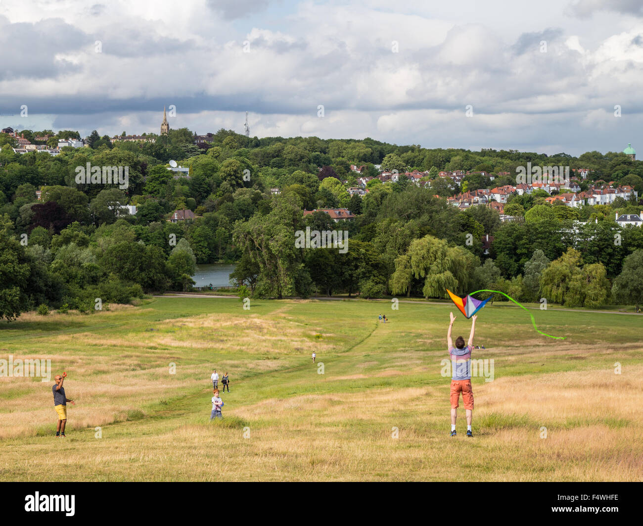 people flying kite on Hampstead Heath, Parliament Hill, London on a