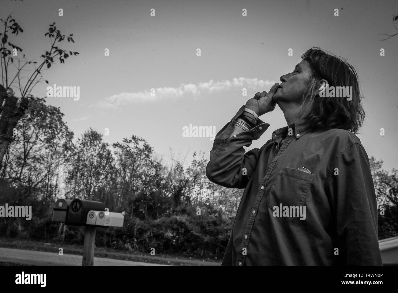 A Merry Prankster makes a prank by making believe that he's smoking a cloud Stock Photo