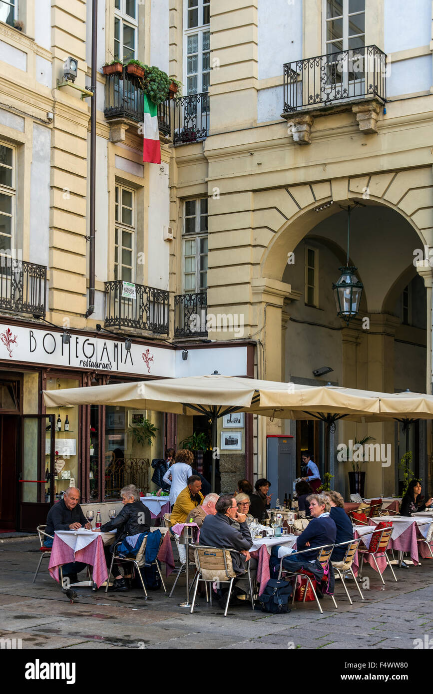 Outdoor restaurant with people seated at tables, Turin, Piedmont, Italy Stock Photo