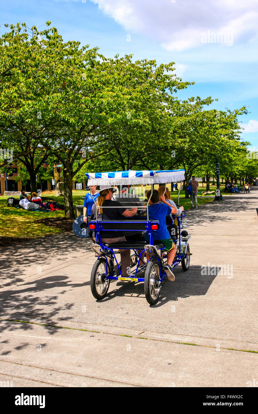 Visitors riding quad-bicycles along the Governor Tom McCall Waterfront Park in Portland Oregon Stock Photo