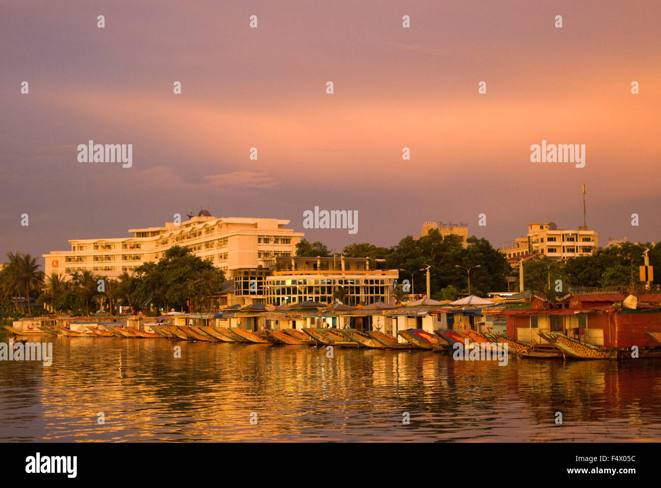 Dragon boat cuises at sunset on the river Huong (Perfume River). Vietnam. Dragon head and excursion boat, Song Huong or Huong Giang or Perfume River, near Hue, North Vietnam, Vietnam, Southeast Asia. Stock Photo