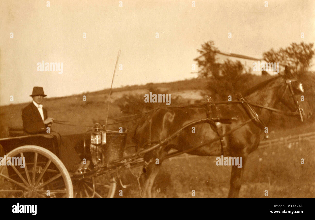 A man driving a cart pulled by a horse, Italy Stock Photo