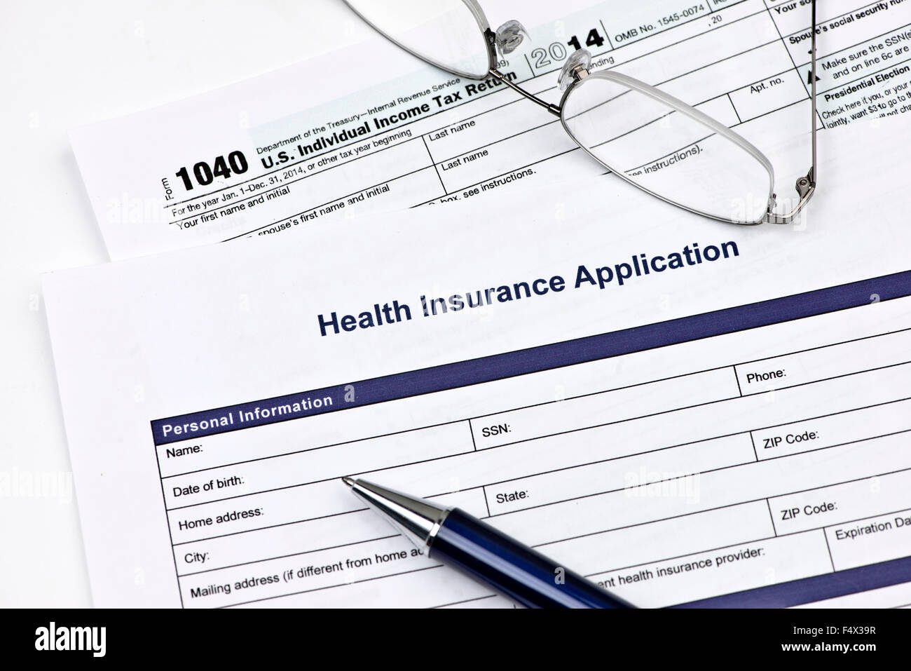 Health insurance application with United States 1040 tax form. Stock Photo