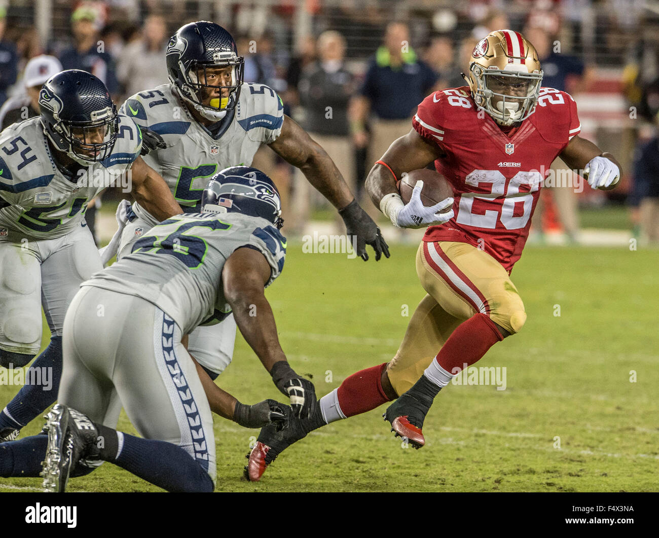 Santa Clara, California, USA. 22nd Oct, 2015. San Francisco 49ers running back Carlos Hyde (28) pulls away from Seattle Seahawks outside linebacker Bruce Irvin (51), middle linebacker Bobby Wagner (54) and defensive end Cliff Avril (56) on Thursday, October 22, 2015, at Levis Stadium in Santa Clara, California. The Seahawks defeated the 49ers 20-3 Al Golub/CSM/Alamy Live News Stock Photo