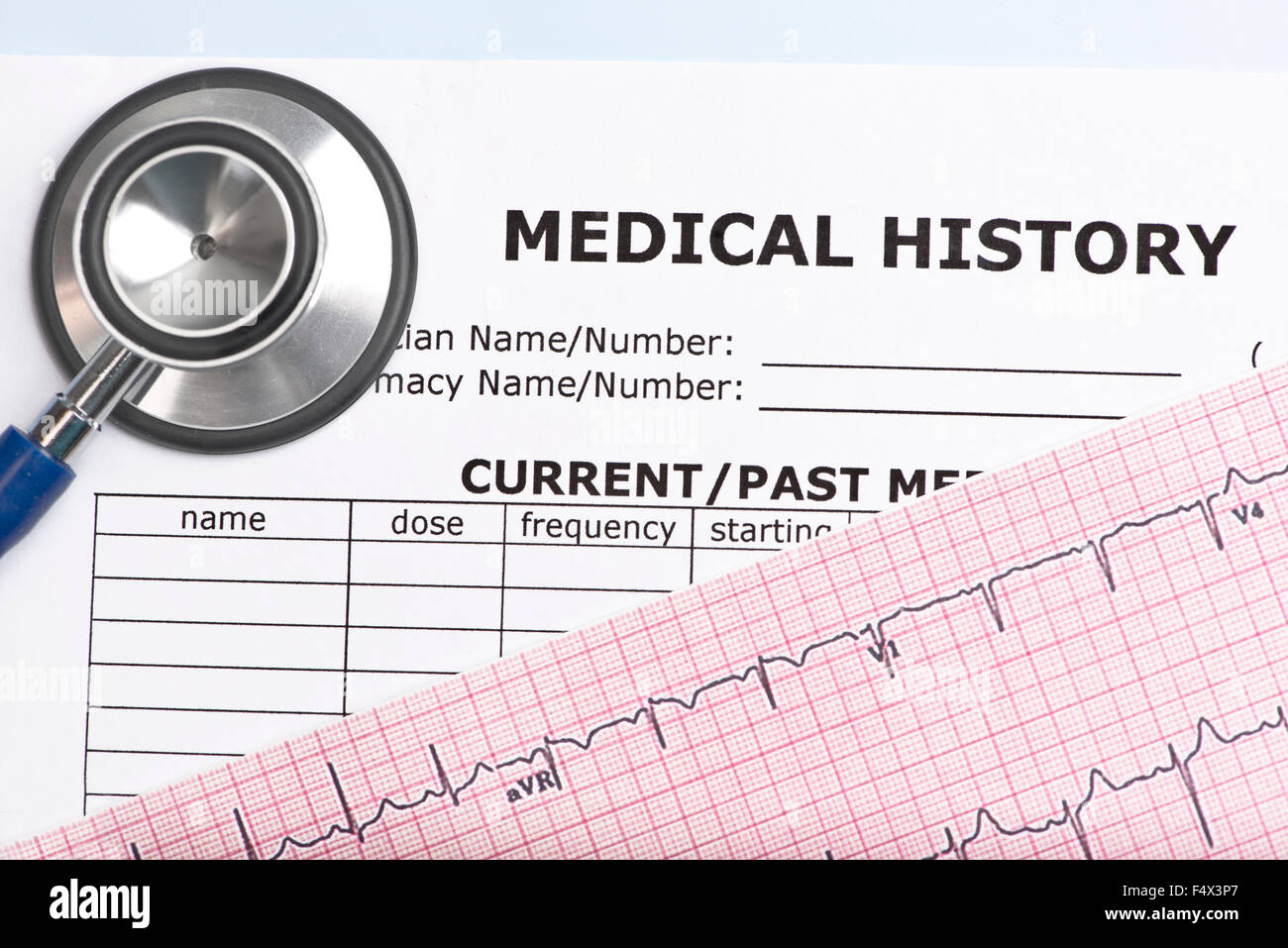 Patient medical history with electrocardiograph and stethoscope. Stock Photo