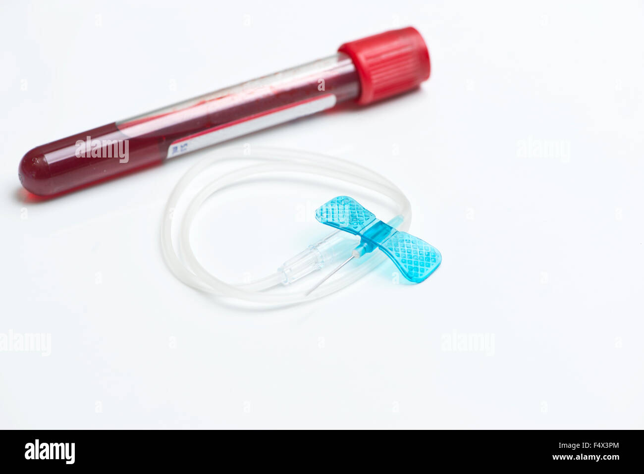 Blood collection tube and small blue butterfly catheter. Stock Photo