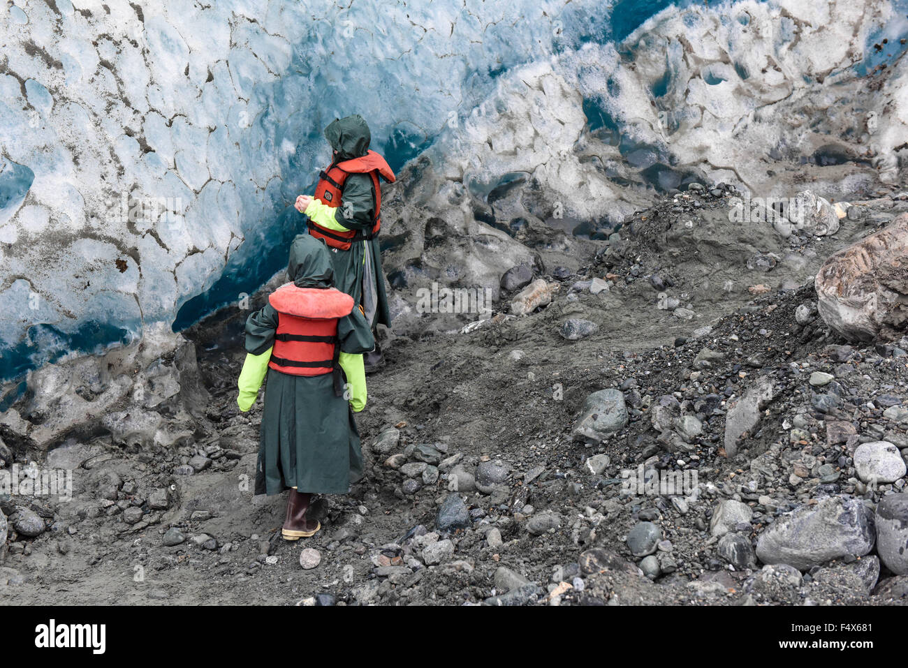 Two boys check out the ice on an Alaskan cruise excursion hike to Davidson glacier near Skagway Alaska | Inside passage - Lynn Canal - Haines AK Stock Photo