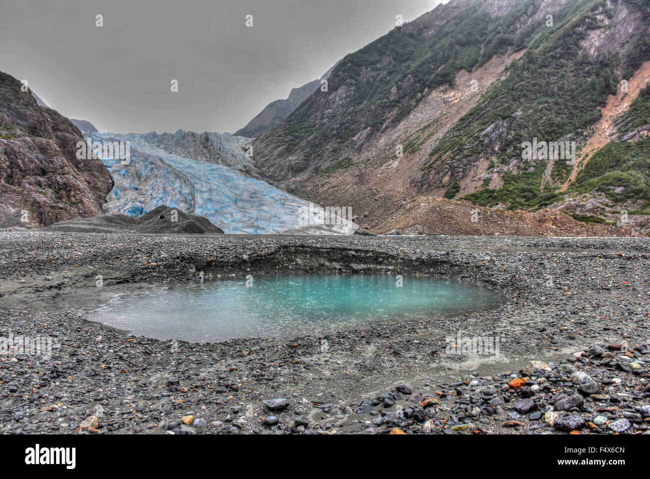 Turquoise pool of water sits in front of Davidson Glacier  / mountains - Haines and Skagway Alaska, United States North America Stock Photo