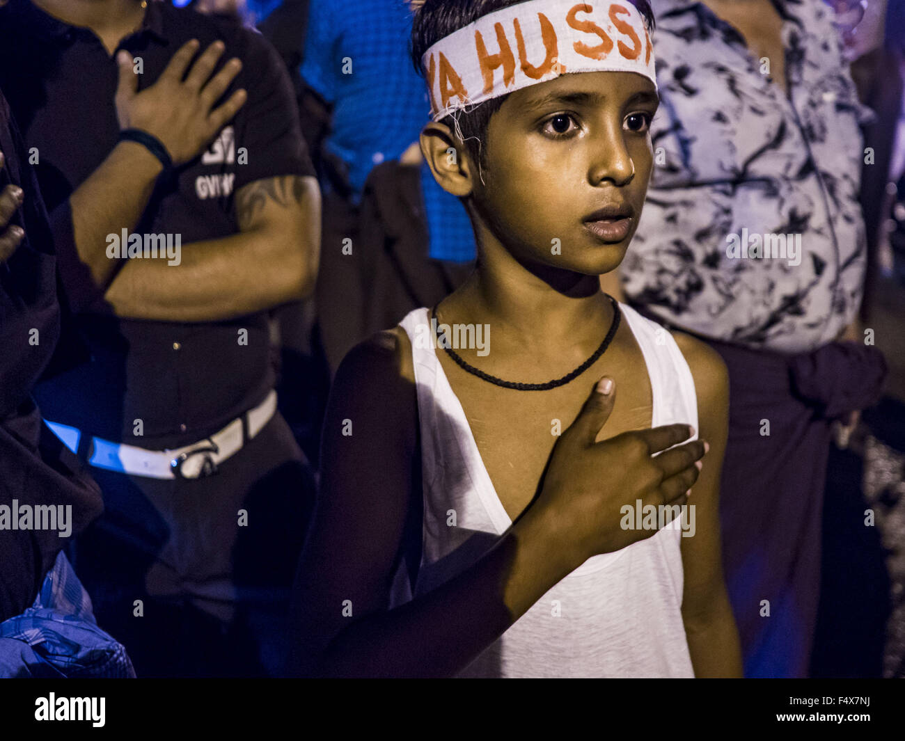 Yangon, Yangon Division, Myanmar. 24th Oct, 2015. A Shia boy pounds his chest during Ashura observances at Mogul Mosque in Yangon. Ashura commemorates the death of Hussein ibn Ali, the grandson of the Prophet Muhammed, in the 7th century. Hussein ibn Ali is considered by Shia Muslims to be the third imam and the rightful successor of Muhammed. He was killed at the Battle of Karbala in 610 CE on the 10th day of Muharram, the first month of the Islamic calendar. According to Myanmar government statistics, only about 4% of the population is Muslim. Many Muslims have fled Myanmar in recent years Stock Photo