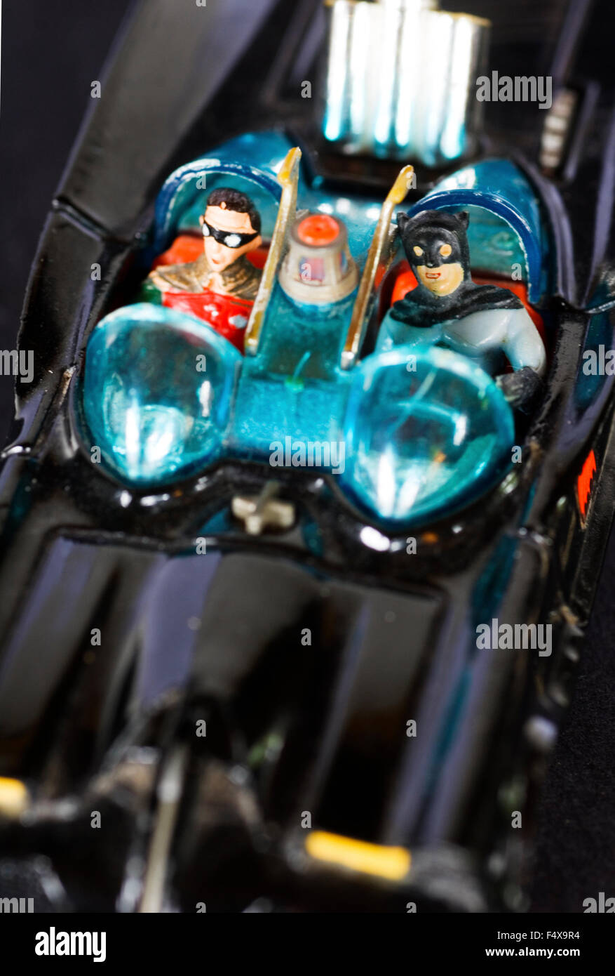 Batman and Robin in the toy Batmobile. Stock Photo