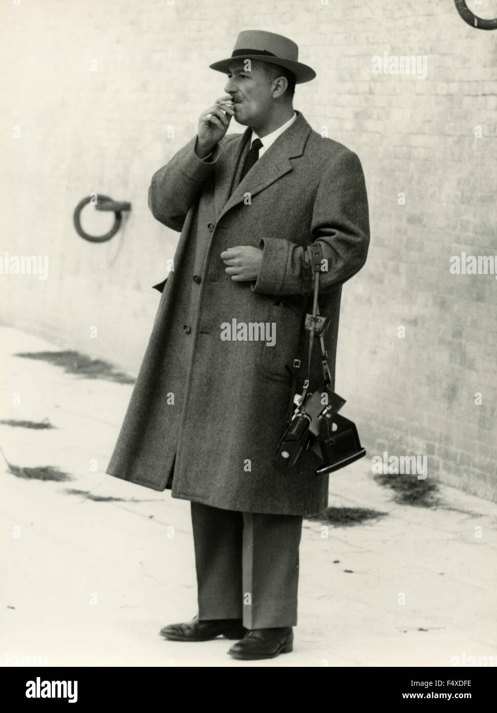 A man with hat, coat and camera, Italy Stock Photo