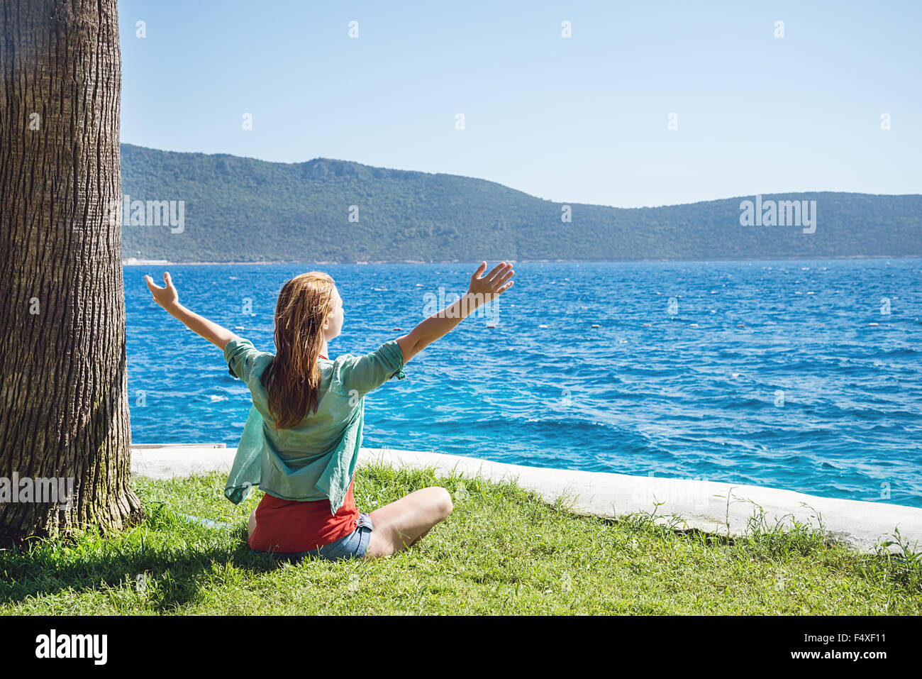 Woman meditating at the sea Stock Photo - Alamy