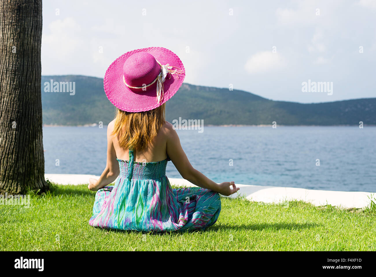 Woman meditating at the sea Stock Photo - Alamy