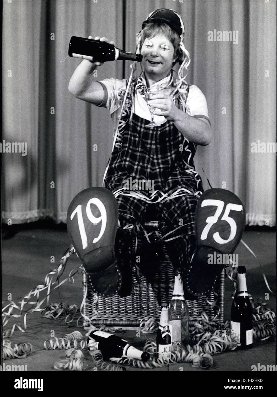 1975 - Son Of Charlie Rivel On Stage In Hamburg: Everybody should hoist one at the beginning of New Year! But not everyone should do like this clown, who has started drinking to it many days before New Year's Eve. However, Juanito, the eldest son of the famous clown Charlie Rival, is ''on duty'' when he empties the bottles, for his private party is part of his performance at the Hamburg Hansa-Theatre. Furthermore he does a parody on Charlie Chaplin, which is a big success. No wonder, even the great comedian himself was impressed by Juanito's parody, when he met him some months ago in Switzerla Stock Photo
