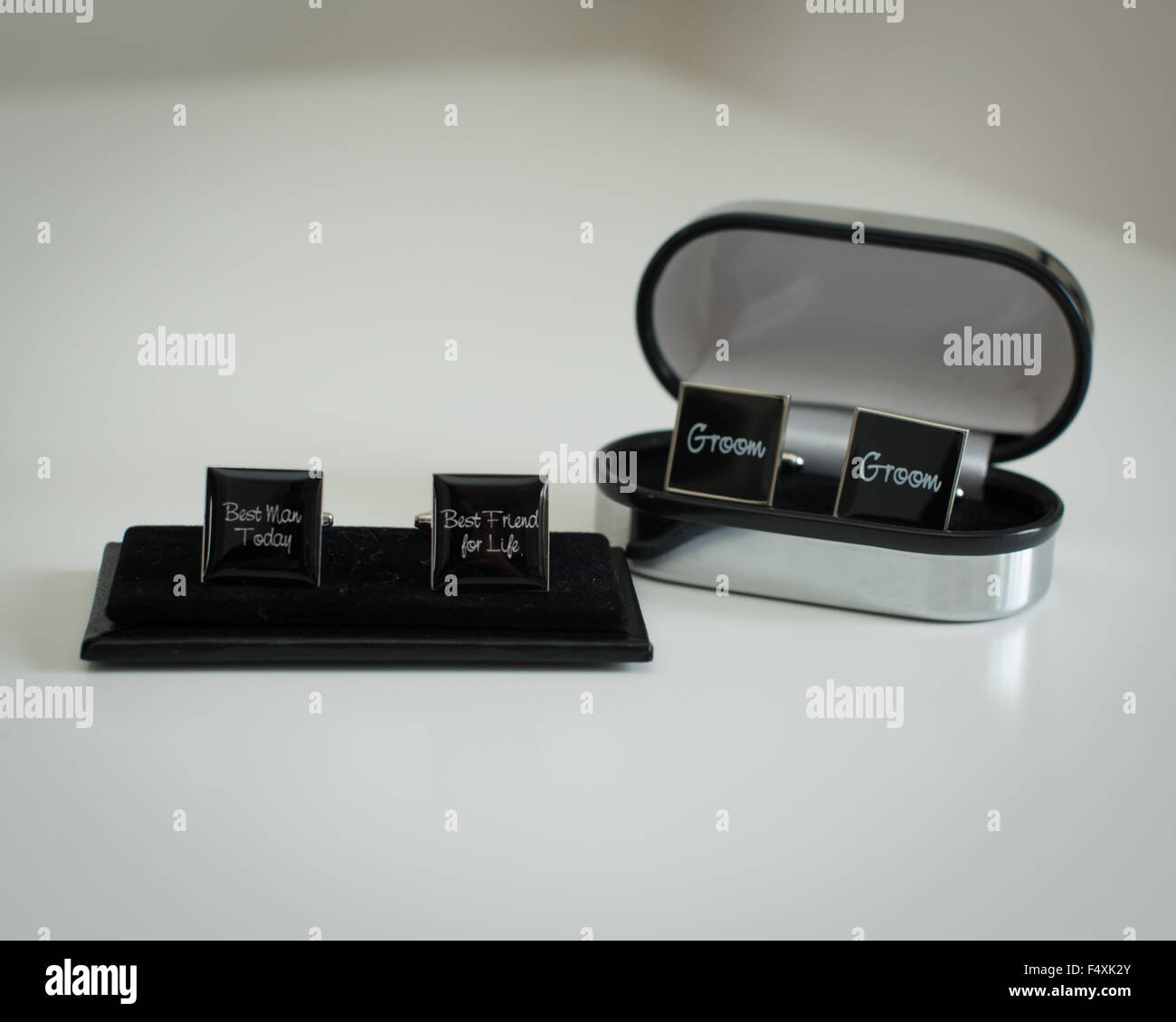 cuff links engraved with best man and cuff links engraved with groom black and silver in display box Stock Photo