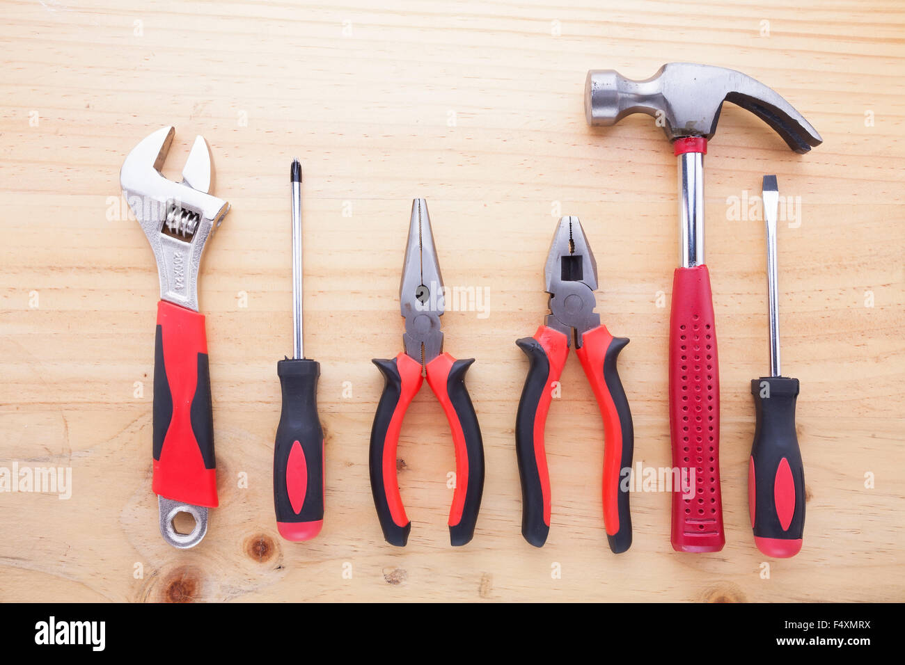 Difference kind of equipments on wooden table (pliers, hammer, wrench