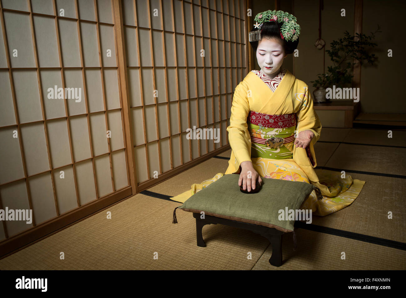 A Maiko  (apprentice geisha) displays some of the skills she has learnt during her apprenticeship. Stock Photo