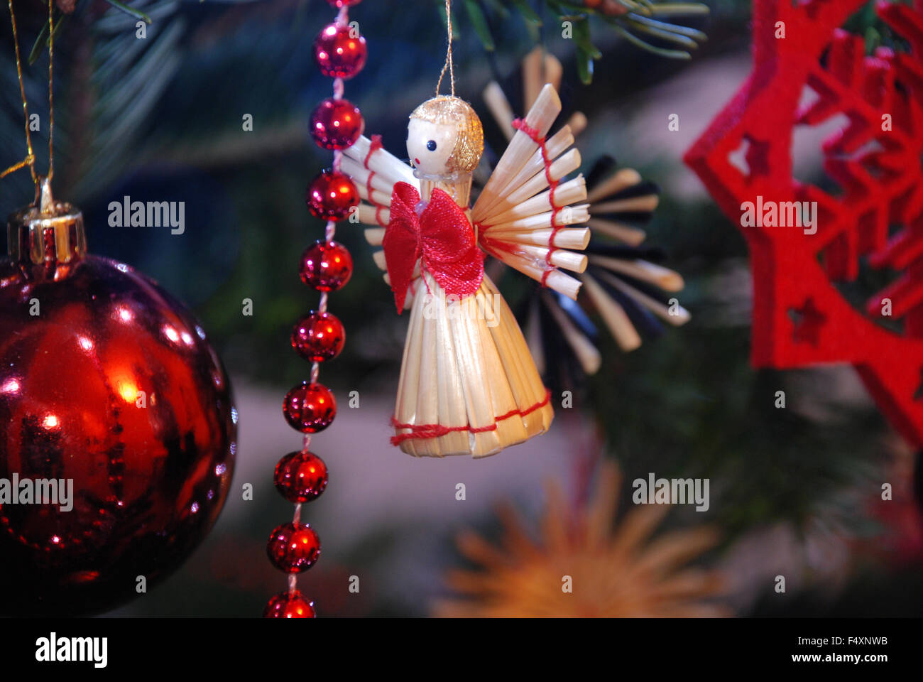 Straw Angel christmas decoration on xmas christmas tree nordman fir in London, England Stock Photo