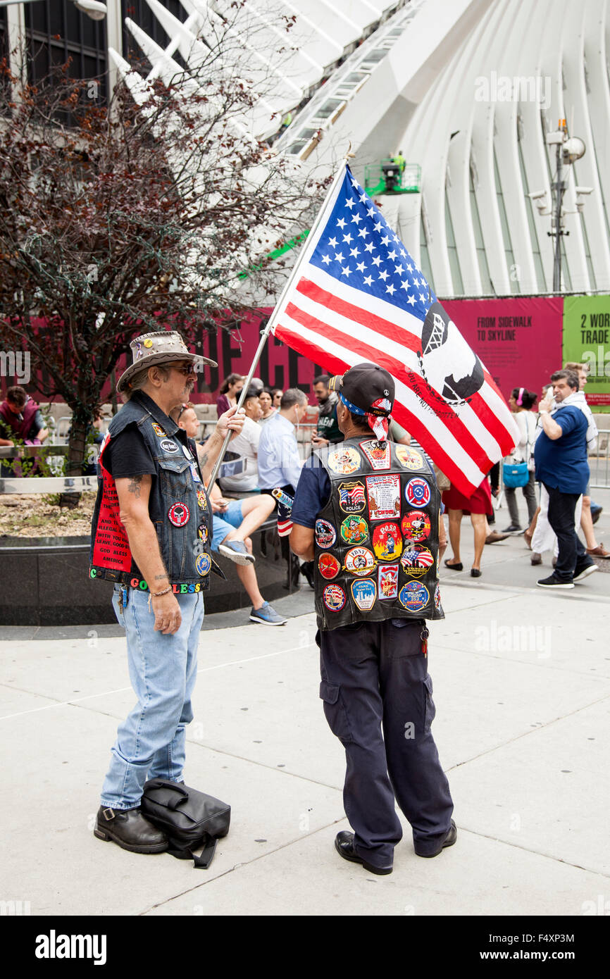 two patriots near ground zero with flag in new york city demonstrate in remembrance of 9-11 Stock Photo
