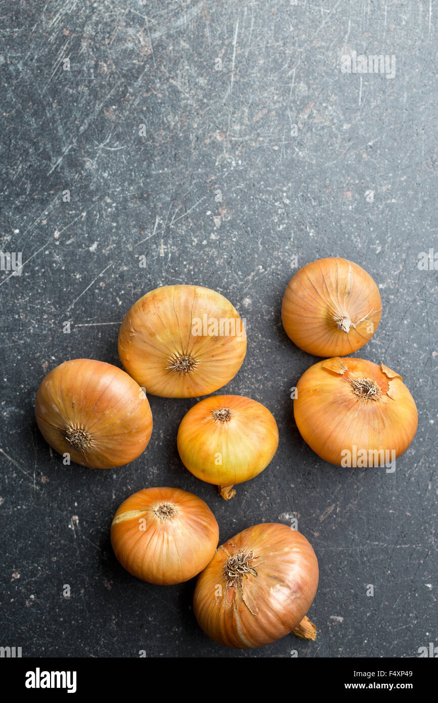 fresh onions on kitchen table Stock Photo