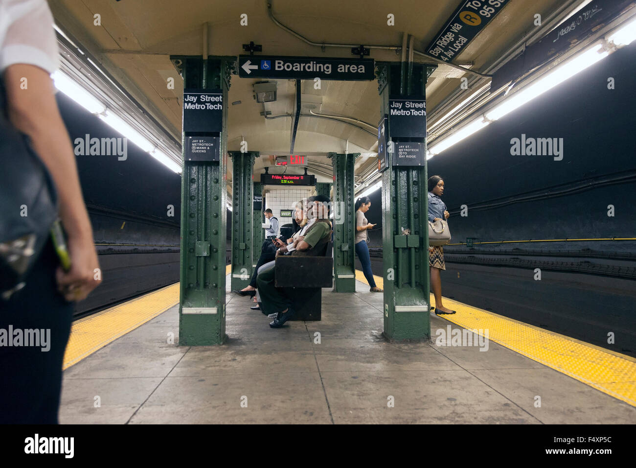 passengers wait on platform of subway station jay street metro tech in