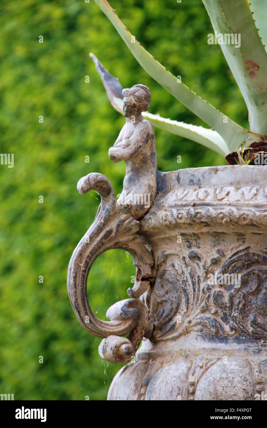 Ornamental flower pot vase garden fairy with aloevera aloe plant cactus in Hampton Court Palace Gardens, London England Stock Photo