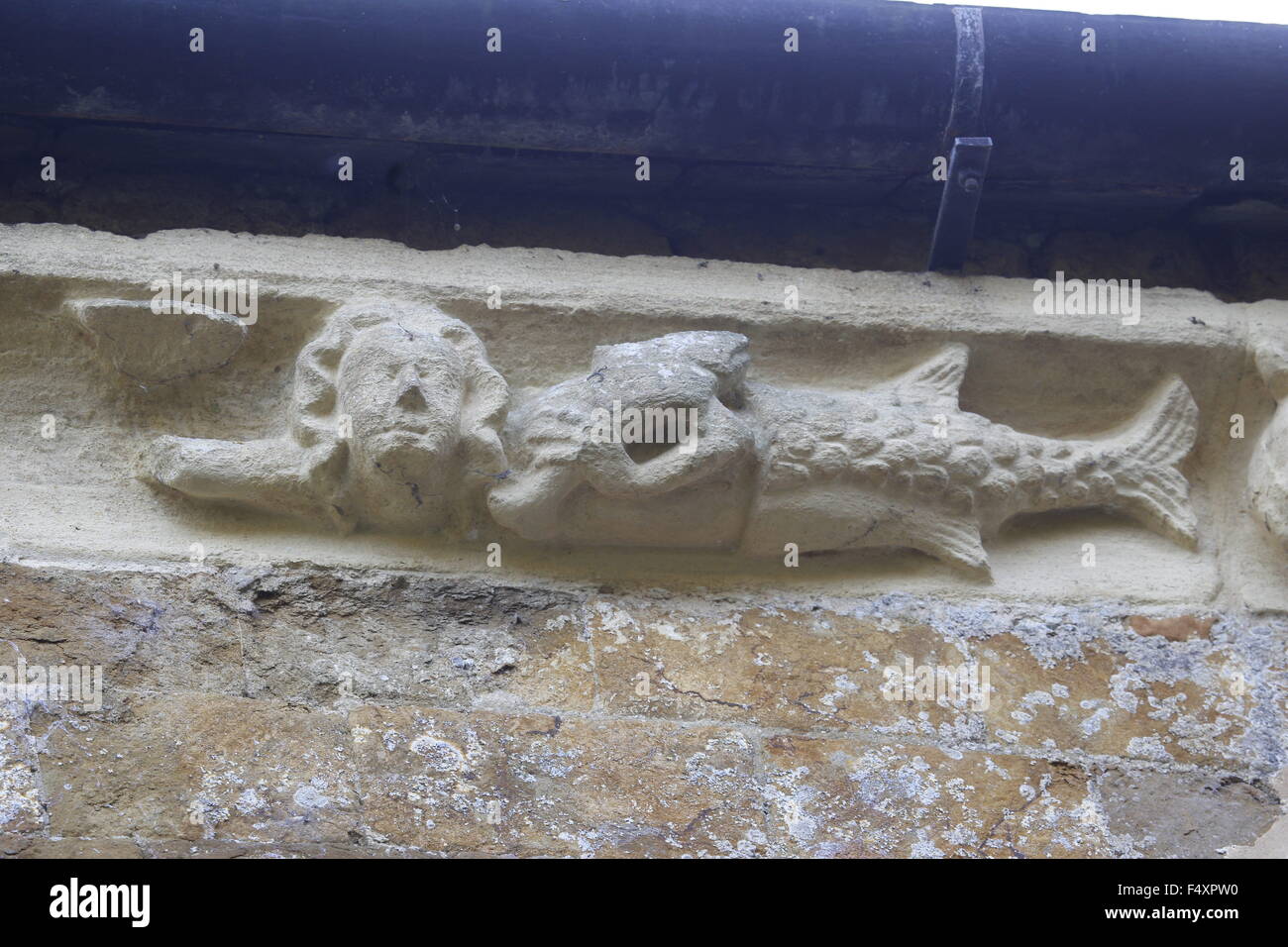 Carving on the Corbel table around the chancel of Hanwell Church, Oxfordshire. Oxford School of Stone Masons Stock Photo